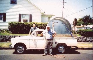 Eric & Keith stand by truck with stock tank in back.